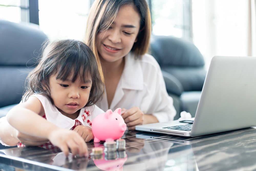 Saving,Money.family,Asian,Saving,Money,In,Piggy,Bank